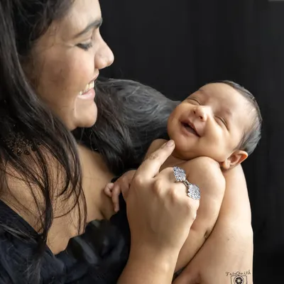 The pure joy of a mother's smile as she looks at her baby. These are the candid, love-filled moments I aim to capture in every family session.