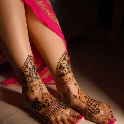 A close-up of a stunning peacock design for the feet. The way the pattern flows from the ankle to the toes is designed to elongate and adorn the feet beautifully.