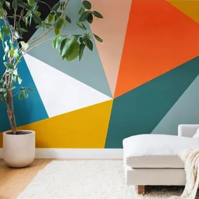 A bold, geometric accent wall featuring a vibrant color palette. This type of custom paint job is perfect for adding energy and a modern artistic touch to a living room or office.