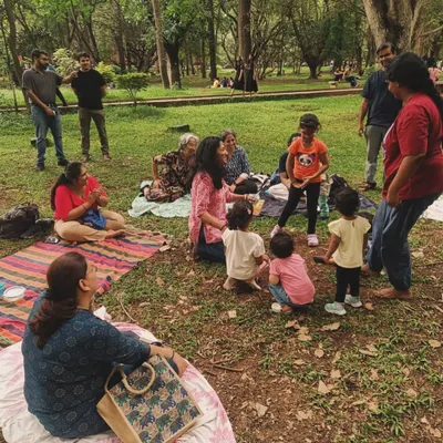 A candid moment from our Mother's Day session, with parents and children gathered on mats, completely engrossed in the story. This is the relaxed, community atmosphere we cherish at our outdoor storytelling workshops.
