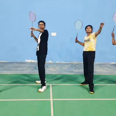 Junior players learning the correct ready stance during a badminton coaching session at the Sunny Brooks Community on Sarjapur Road.