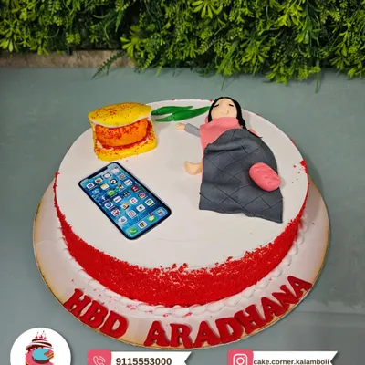 A cake for the ultimate Mumbaikar: a Vada Pav themed cake! This fun design features a fondant figure enjoying a vada pav while scrolling on her phone.