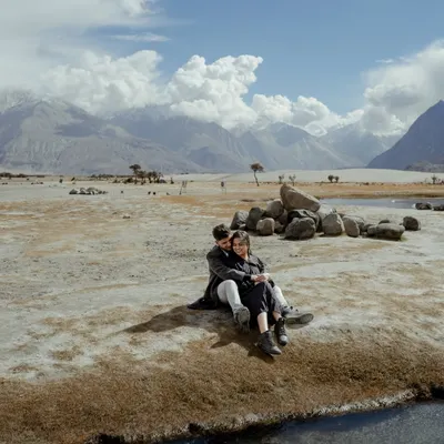 Finding a quiet corner in the vast, stunning landscape of Ladakh. This shot shows how we use epic scenery to frame an intimate moment, making the world feel like it belongs only to you.