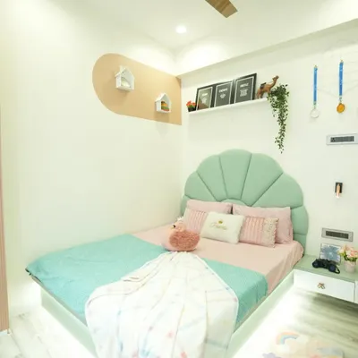 A dream room for a little princess. We designed this bedroom with a soft pastel color palette, a custom-made shell-shaped headboard, and whimsical details to create a magical and cozy space.