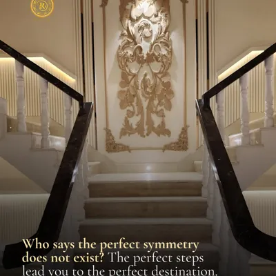Who says perfect symmetry does not exist? This grand staircase with its marble steps, ornate wall molding, and balanced design leads you to the perfect destination in style.
