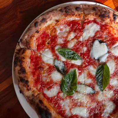 Pizza the way it was meant to be. Our Margherita has no frills, just pure flavour from high-quality tomatoes, fresh mozzarella, basil, and our signature dough.