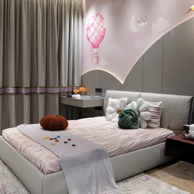 This little girl's room balances luxury and practicality with a whimsical hot-air balloon mural. We used a soothing pastel palette, custom furniture with smart storage, and layered textures to create a magical yet timeless space that can evolve with her.