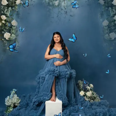 A fairytale comes to life. This dreamy setup with a floral arch, flowing blue gown, and magical butterflies is one of my most requested concepts.