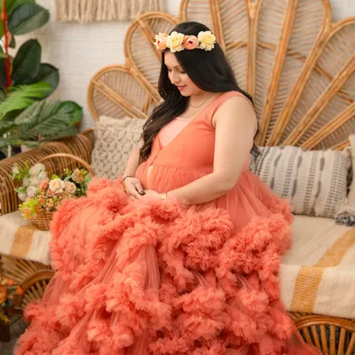 This voluminous peach tulle gown is a client favorite for a reason. Its layers of ruffles create a stunning, romantic silhouette that makes for truly breathtaking maternity portraits. Here it is styled with a delicate floral crown.