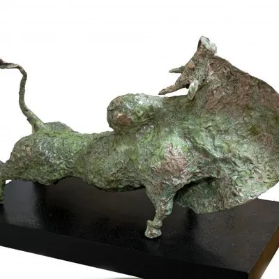 This bronze sculpture by P. Elanchezhiyan is a fantastic study of a bull in motion. The artist has masterfully captured the animal's muscular form and powerful forward momentum.