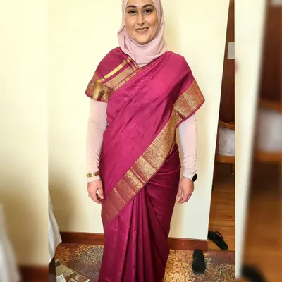 Draping a beautiful magenta silk saree while elegantly incorporating a hijab. I ensure the style is modest, comfortable, and respectful of my client's preferences.