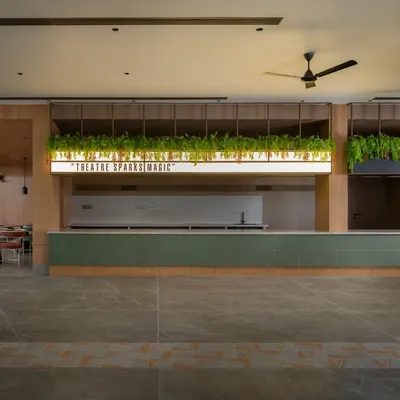 The main lobby and reception counter at the Sri Kumaran School auditorium. We designed this area to be the first point of immersion, with warm lighting, natural wood, and greenery creating a welcoming atmosphere for students and visitors.