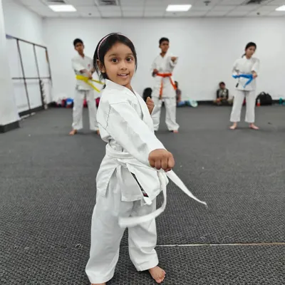 The joy and focus on a young student's face during class. My goal is to create a positive and encouraging environment where children can fall in love with the art of karate.