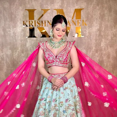 This client is ready for her sangeet in a modern pastel lehenga, paired with a rented mint green and polki necklace set.