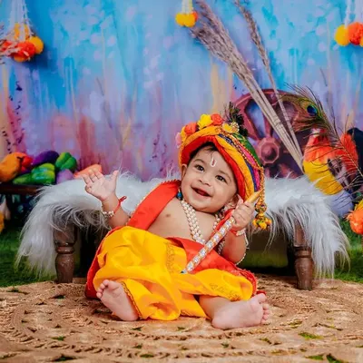 Navaratri moments with our little mischief-maker, Krishna. The vibrant colors of this setup are full of festive joy.