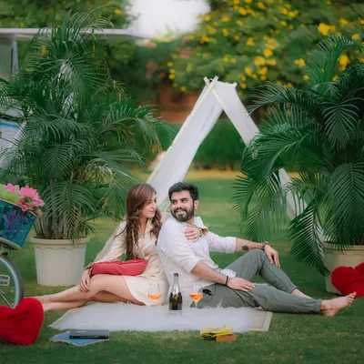A couple enjoying a romantic picnic on the lawn, with our unique yellow airplane prop in the background. This setup is perfect for a fun, travel-themed pre-wedding photoshoot.