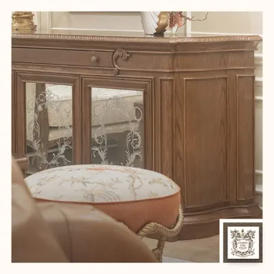 This wooden console is a perfect example of timeless sophistication. The piece features intricate carvings, a rich wood grain, and elegant mirrored doors with floral etching, bringing a sense of grandeur to any living space.
