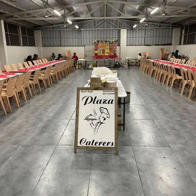 Our setup at RR Party Hall in Maddur, ready for the event to start. You can see our branded sign at the entrance, with the dining area neatly arranged in the background.