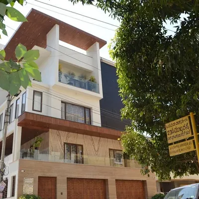 The exterior of a completed residence in HSR Layout, where I handled both architecture and interiors. The facade uses natural stone and wood overhangs to create a warm, modern aesthetic.