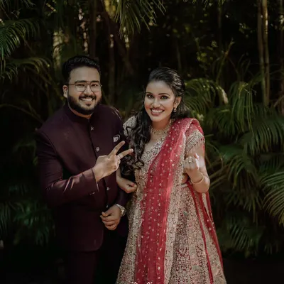 A fun and happy portrait of the couple, their playful gestures showing the joy of their engagement celebration.