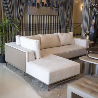 Simplicity meets contemporary design in our Oslo Sofa. We designed this piece with a sleek L-shape, upholstered in a combination of muted taupe leatherette and off-white fabric, to create a statement of modern comfort for any living room.