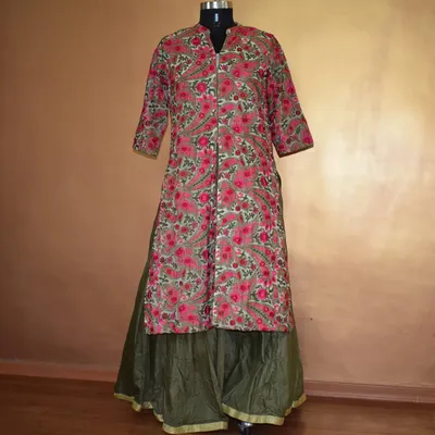 This long, front-slit kurta with a bold floral print is paired with a solid olive green skirt. It’s a comfortable yet striking outfit that perfectly blends Indian and Western aesthetics.