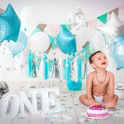 A classic first birthday cake smash is a perfect way to celebrate. I set up this bright and cheerful scene with a custom cake and balloons in my studio to capture this little boy's happy mess.