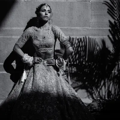 A powerful black and white bridal portrait of Amala. The dramatic shadows and strong pose at Umaid Bhawan Palace create a high-fashion, editorial look.