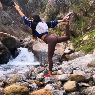 Finding my balance with Natarajasana (Dancer's Pose) by a waterfall. Practicing on uneven, natural surfaces adds an extra challenge and deepens your connection to the earth.