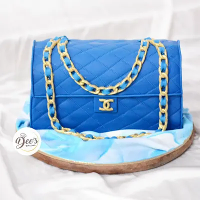 Why buy a Chanel bag when you can eat one? This realistic handbag cake is sculpted from cake and covered in quilted blue fondant with a detailed gold chain.
