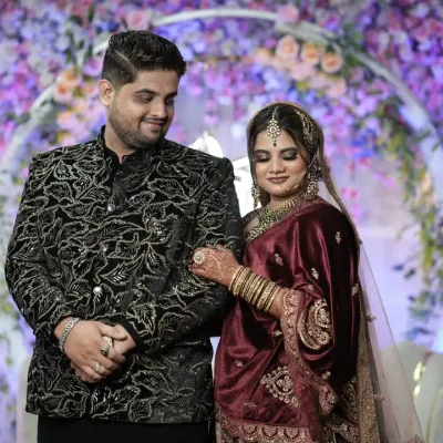 A sweet, smiling interaction between a newly married couple at their reception, showcasing their beautiful coordinated outfits.