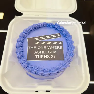A fun bento cake with a 'Friends' TV show theme. These mini cakes, packed in a lunchbox, are perfect for celebrating milestones like a 27th birthday.