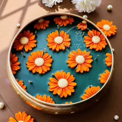 This was a very special custom order for a wedding gift: a grand 10-inch urli filled with bright orange daisy candles. The piece is scented with a beautiful blend of Jasmine and Ylang Ylang, making it a truly luxurious and memorable gift.