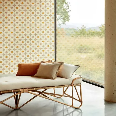 Channeling the essence of an urban oasis, this room features a geometric raffia wallcovering that complements the natural light and minimalist furniture. The design breathes texture, balance, and quiet sophistication into the space.