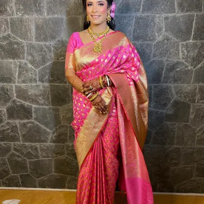 A full-length view of my beautiful reception bride in a stunning pink Banarasi saree. The makeup is bright and celebratory, with pink tones that echo the color of her outfit.