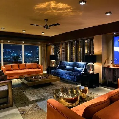 For this weekend home in Magnolias, Gurgaon, the goal was a heightened dramatic appeal. The living room is designed as an art object, with vibrant colours like deep orange and royal blue set against the glittering city skyline.