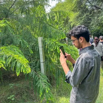A student from Amity University taking a moment to photograph a plant. We encourage this on our walks. Photography makes you pause and observe the details you might otherwise walk right past.