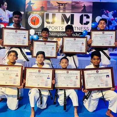 Our newest group of black belt recipients proudly display their hard-earned certificates. This is a huge milestone in their martial arts journey.