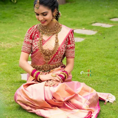 A flawless traditional look created for a festive photoshoot. This look features a beautiful pink Kanchipuram saree, antique gold jewellery, and classic makeup with defined eyes and a soft lip.