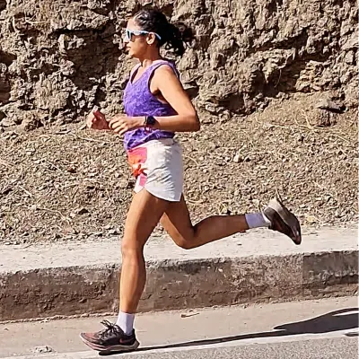 Distance teaches endurance, but hills teach grit. A powerful stride during a hill training session, building the strength needed to conquer any incline.