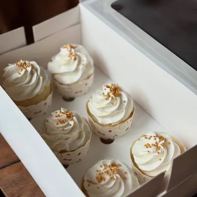 A box of my classic vanilla cupcakes. Sometimes simple is best. These are topped with creamy vanilla bean frosting and a sprinkle of gold sugar.