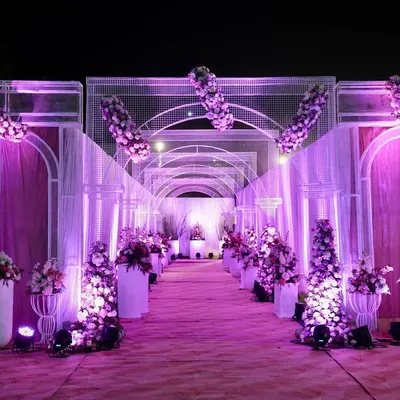 I designed this stunning floral tunnel to give guests a truly grand entrance. The combination of purple uplighting, white framework, and dense floral arrangements created a dramatic and immersive walkway, setting a luxurious tone for the wedding reception.