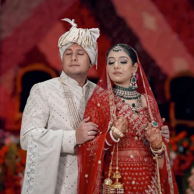 A serene and intimate moment between the bride and groom during their wedding ceremony, their eyes closed in quiet reflection.