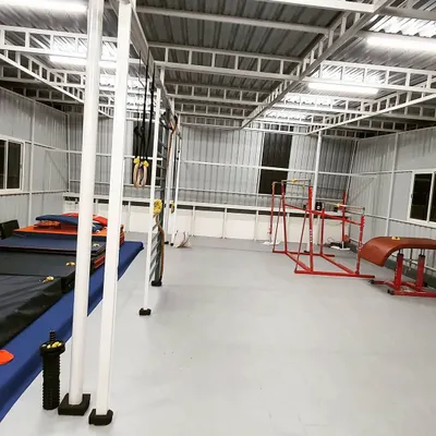 A wide view of our gymnastics training center, showing the various mats, bars, and equipment we use to provide a comprehensive learning experience.