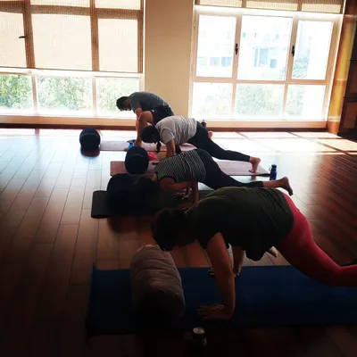 A shot of students fully engaged during an arm balance workshop at the Svadhyaya studio in Powai. Everyone is focused on their own mat, but the collective energy is strong.