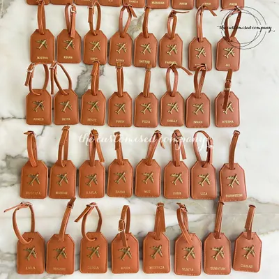 Gearing up for a big group trip? This image shows a large order of personalized vegan leather luggage tags, each customized with a name. It’s a great way to keep luggage organized and easily identifiable.