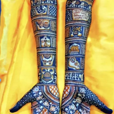 This design features story panels filled with traditional Rajasthani motifs, including elephants, kalash, and doli, creating a narrative up the arm. The dark stain shows the quality of my organic henna.