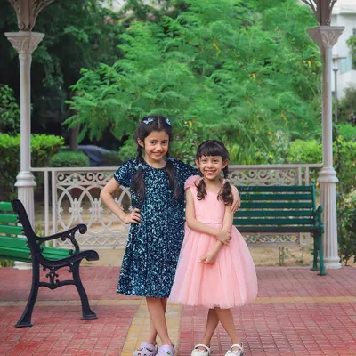 There is no better friend than a sister. These two lovely sisters are posing in pretty dresses for a brand collaboration, captured during a fun outdoor shoot.