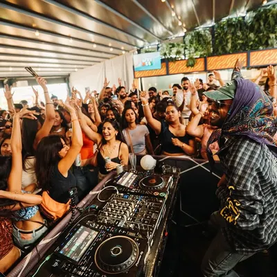 A view from my perspective at a packed London day party. The energy from a crowd like this is what fuels my performance. This is the vibrant, high-energy atmosphere I create.