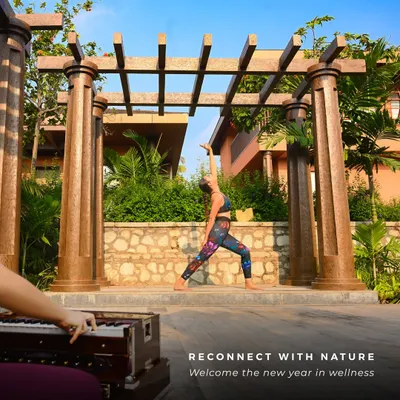 A guest finds her balance in a warrior pose during an outdoor yoga session. Practicing on our deck, surrounded by the resort's architecture and gardens, adds a unique element of grounding and inspiration to your flow.